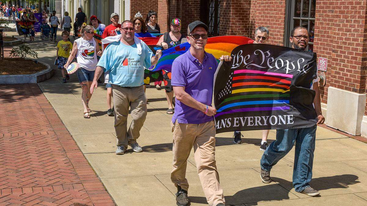 Jeremey Hobbs and Harry Underwood carry the We the People flag while leading a group of marchers along the sidewalks of Broadway during 2019 LGBT Pride Festival parade Saturday afternoon. Colgay Pride hosted a series of events as part of the LGBT Pride Festival in Columbus, Georgia, starting with a Mr. and Ms. Columbus Georgia Pride Pageant Friday evening and concluding Sunday with the festival’s family day.