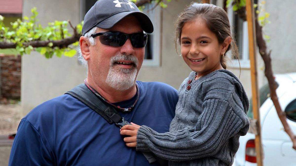 Chance Galloway holds a Bulgarian child he has worked with during his mission work there.