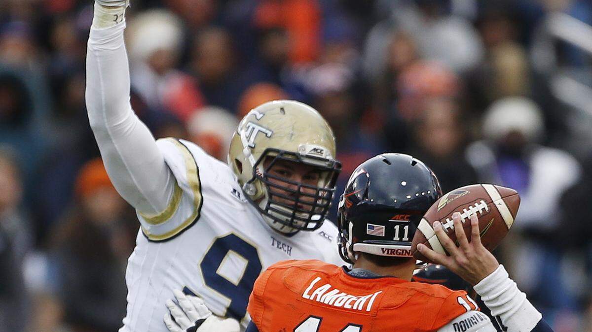 MIKE STEWART/Associated PressGeorgia Tech defensive lineman Adam Gotsis (96) rushes Virginia quarterback Greyson Lambert during the first half Nov. 1, 2014, in Atlanta.