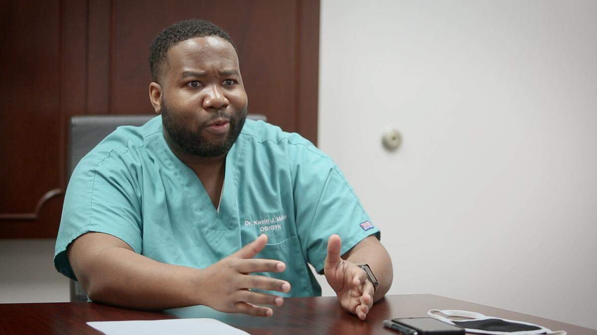 When talking with pregnant patients, Dr. Kevin McRae, an obstetrician-gynecologist at St. Francis-Emory Hospital, encourages them to get vaccinated, at his office in Columbus, Ga. on Oct. 27, 2021.
