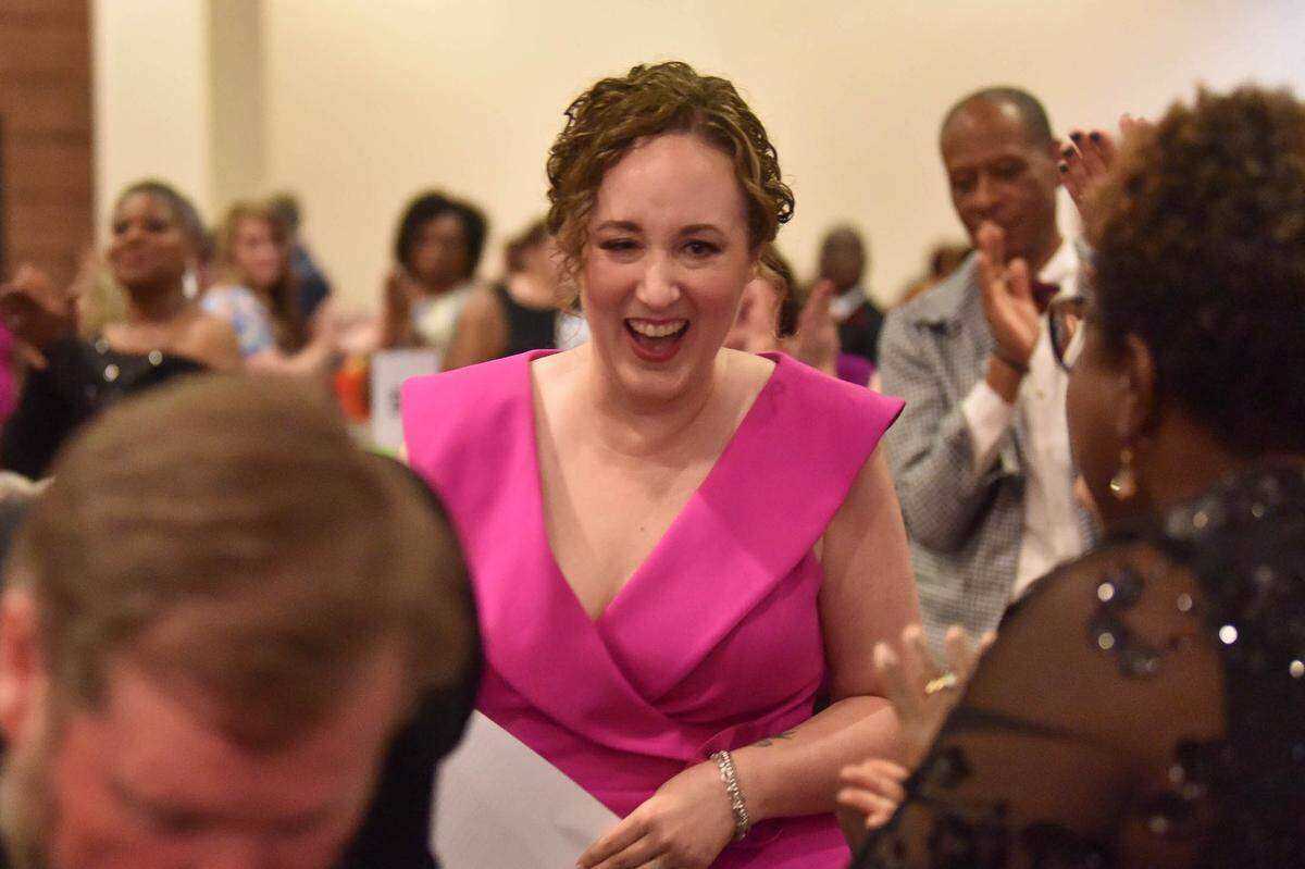 During the Muscogee Educational Excellence Foundation gala May 9, 2024, in the Columbus Convention & Trade Center, Christie Akers of Northside High School walks to the stage after she was announced as the Muscogee County School District 2024 Teacher of the Year.