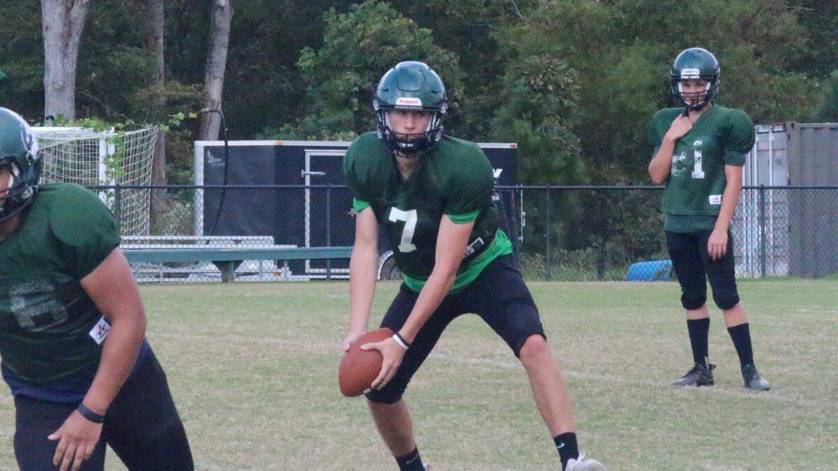 Calvary Christian quarterback Jesse Donohoe tosses the ball to a running back during a practice on Oct. 21, 2020.