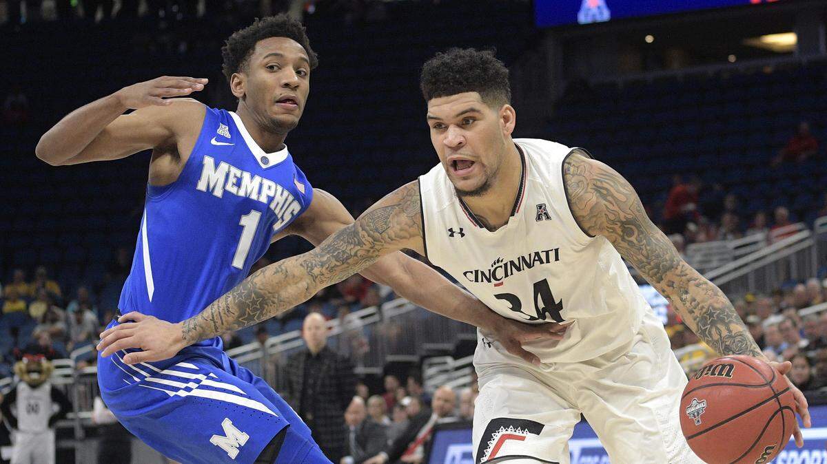 Cincinnati guard Jarron Cumberland (34) drives to the basket in front of Memphis guard Jamal Johnson (1) during the first half of an NCAA college basketball game in the semifinals at the American Athletic Conference tournament Saturday, March 10, 2018, in Orlando, Fla.