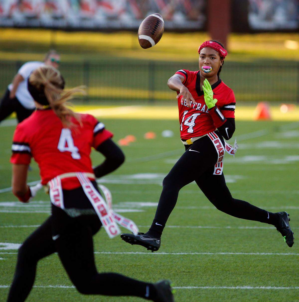 Central High School’s Mariah Harrison, right, throws a pass to teammate Natalyn Lumpkin Monday afternoon during Central’s varsity flag football gamea gainst Brewbaker Tech at Garrett-Harrison Stadium in Phenix City, Alabama. 10/14/2024