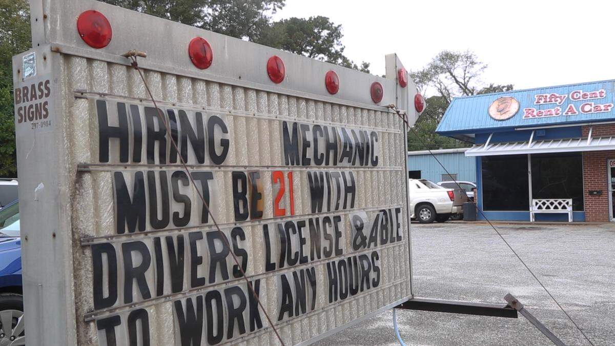 A hiring sign outside of White’s Automotive Center in Columbus, Ga. on Nov. 5, 2021.