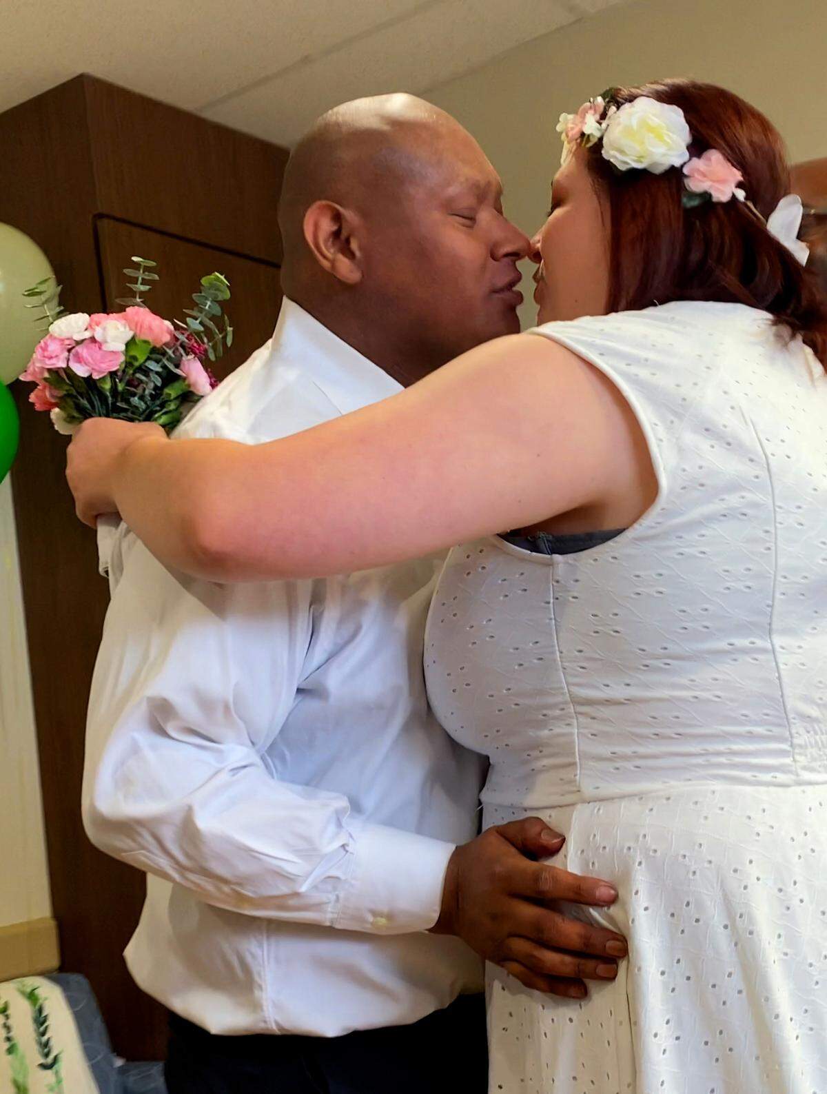 Alexander Ramirez Santos, left, married his fiancé Heather Renee Duke in his hospital room at Piedmont Columbus Regional’s Midtown Campus Wednesday afternoon. Pastor Marlon Scott officiated the ceremony. 07/20/2023