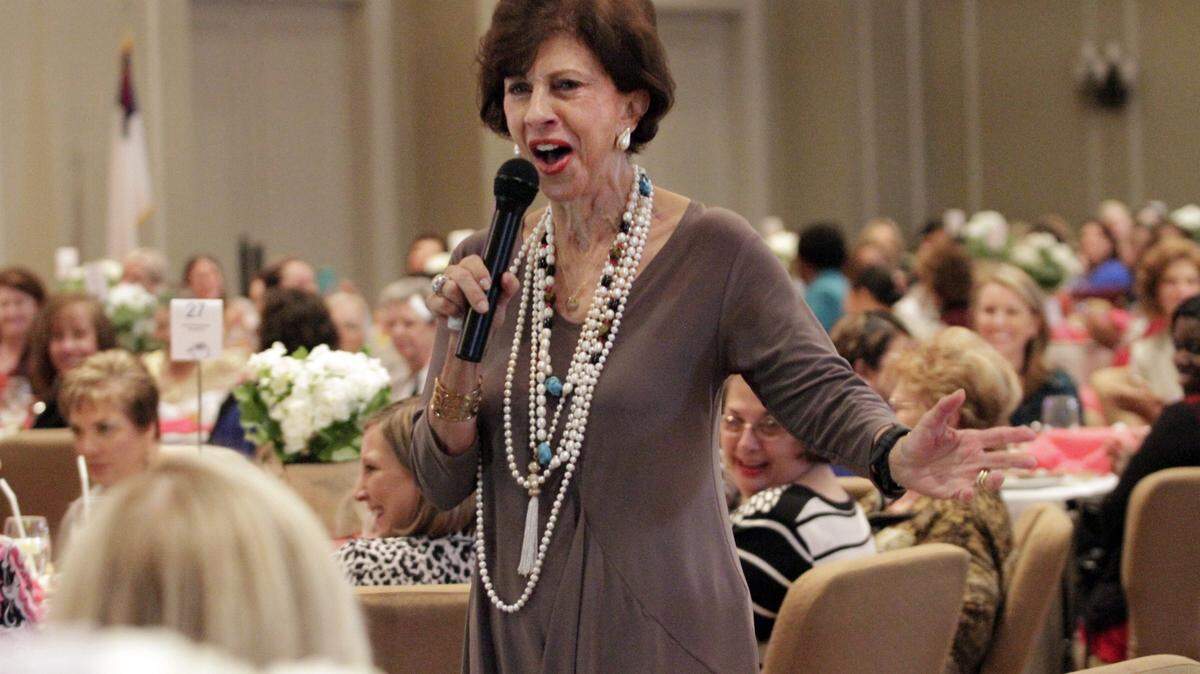 ROBIN TRIMARCHI rtrimarchi@ledger-enquirer.com 
 Barbara Dooley walks through the crowd and sings the Stevie Wonder song, "I Just Called to Say I Love You," during the Fourth Annual Women's Leadership "Power of the Purse" Luncheon Wednesday at the St. Luke Ministry Center. The annual event supports the "Wear One, Bring One" program that provides new undergarments to women and girls in need. Gift bags of undergarments line the stage, and thousands of gifts and vouchers for personal fittings and purchases at local department stores have been donated over the years. Dooley told personal stories from her 50 years of marriage to longtime University of Georgia football coach Vince Dooley, and refrenced biblical scriptures to talk about love and generous spirit of giving. 11.18.15