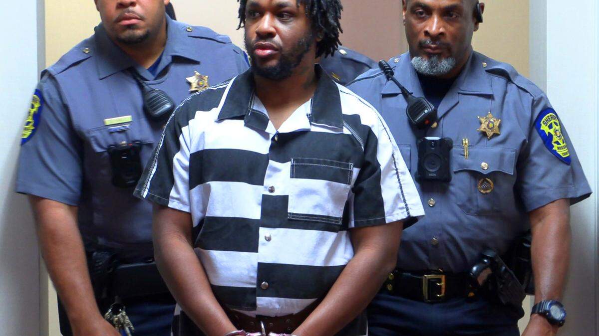 Jeremy Tremaine Williams, center, is escorted to a courtroom Wednesday afternoon for a hearing before Circuit Court Judge David Johnson at the Russell County Courthouse in Phenix City, Alabama. 03/13/2024
