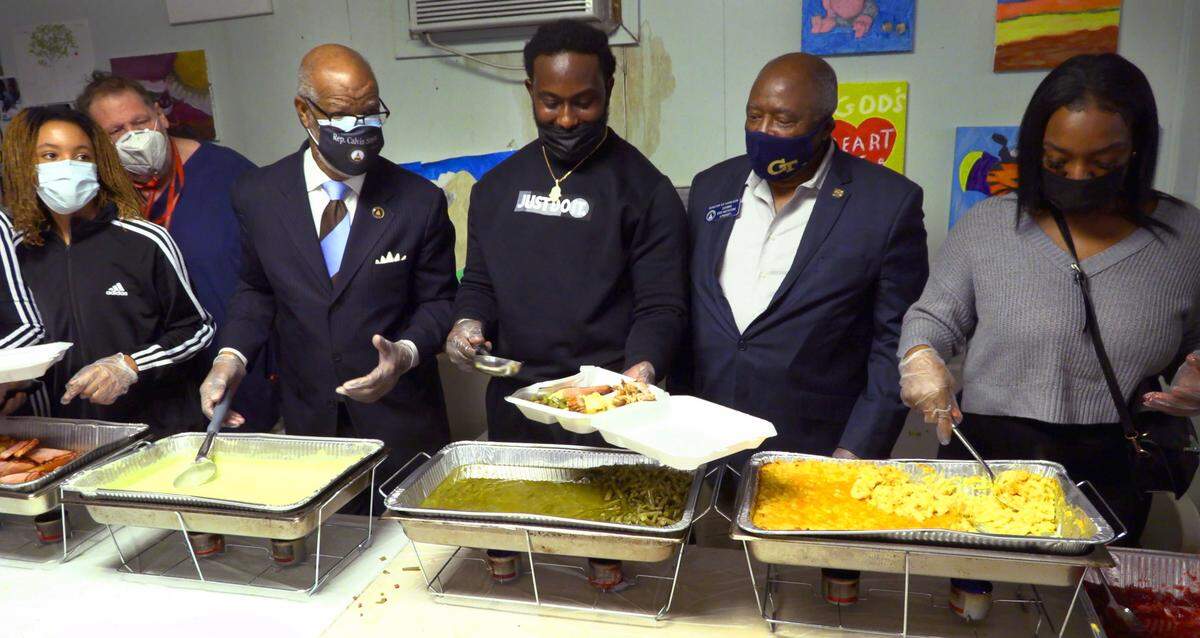 Isaiah Crowell, center, serves an early Thanksgiving meal Nov. 24, 2020, at SafeHouse in Columbus, Georgia. The meal was provided by Isaiah Crowell and his Feed the Crow Foundation Inc. Crowell is a Carver High School graduate, and more widely known for his time as at the University of Georgia, Alabama State and in the NFL.