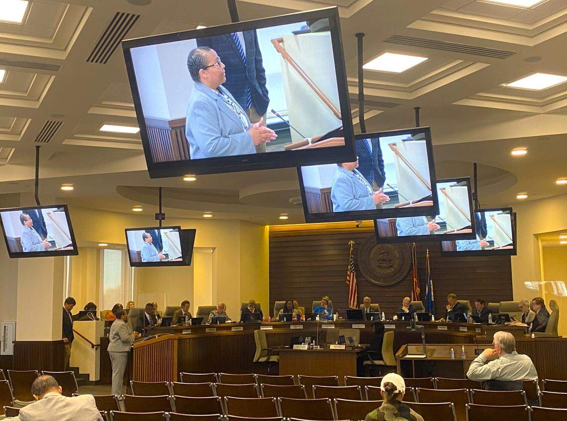 City Finance Director Angelica Alexander appears on overhead monitors as she briefs Columbus Council on a backlog in city business license renewals.