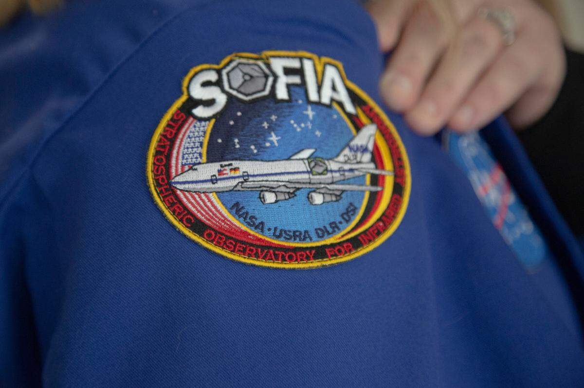 Science teacher Laura Solomons shows her patch from a NASA flight on the aircraft SOFIA, an airborne observatory run by NASA, at Columbus High School on August 25, 2021 in Columbus, Ga.