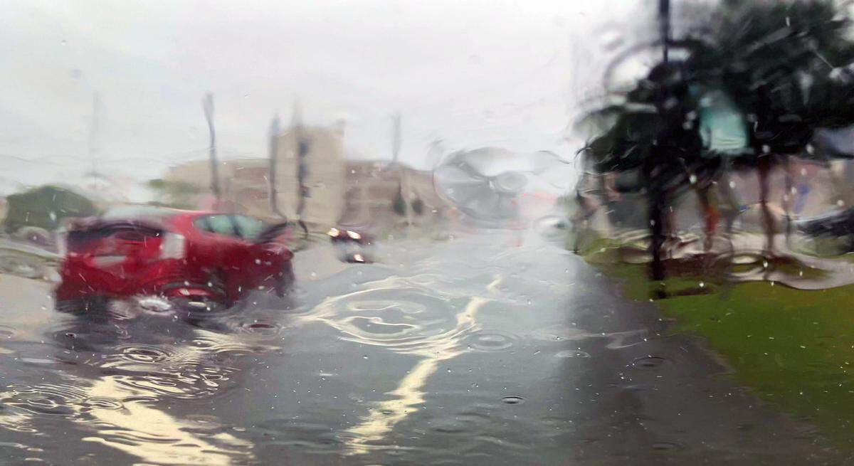 A heavy downpour caused by Hurricane Helene and the associated storm system obscures the view through a car’s front windshield on Thursday afternoon. 09/27/2024