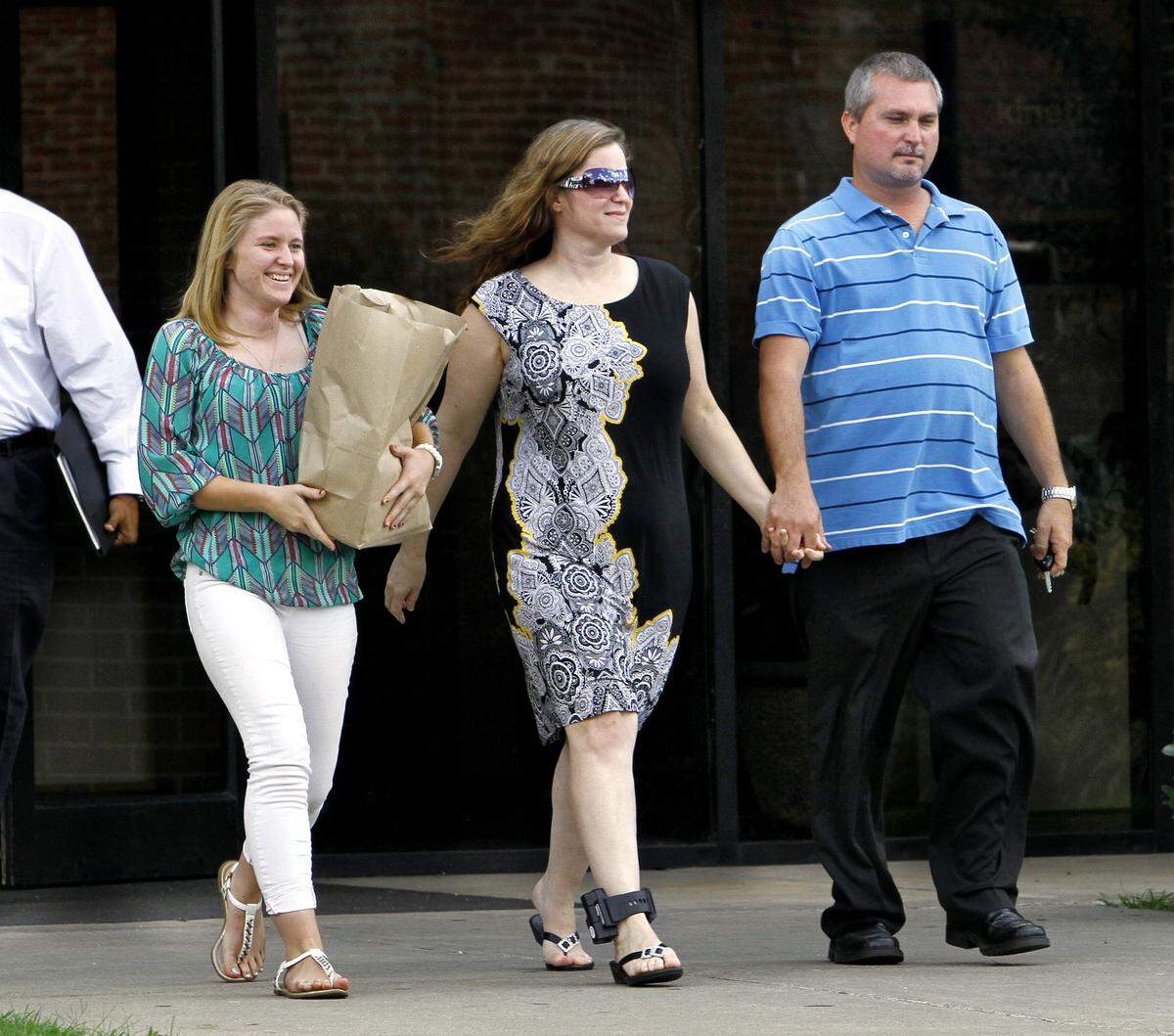 Rebecca Smith Haynie, center, leaves the Muscogee County Jail while wearing an ankle monitor after posting bond in September 2014. Haynie is accused, along with Donald Keith “Bull” Phillips, in the March 2004 shooting death of her then-husband Kirby Smith, Jr. The man and woman in the photo are unidentified.