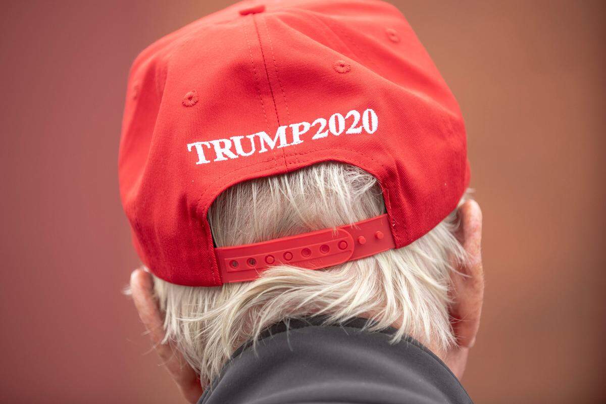 A Trump supporter listens to Gov. Brian Kemp speak at a MAGA rally in Manchester, Georgia, on Oct. 27, 2020. The rally was held on the same day Joe Biden visited Warm Springs just a few miles away.