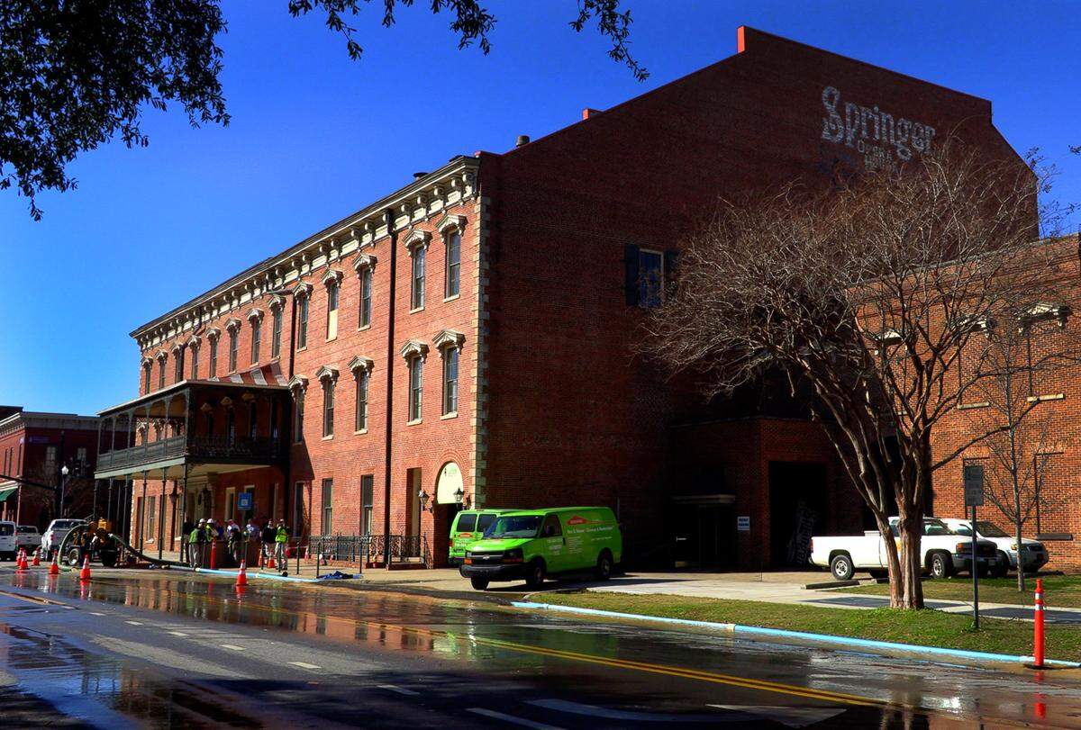 Workers pump water from the flooded basement at the Springer Opera House shortly after it flooded in February.