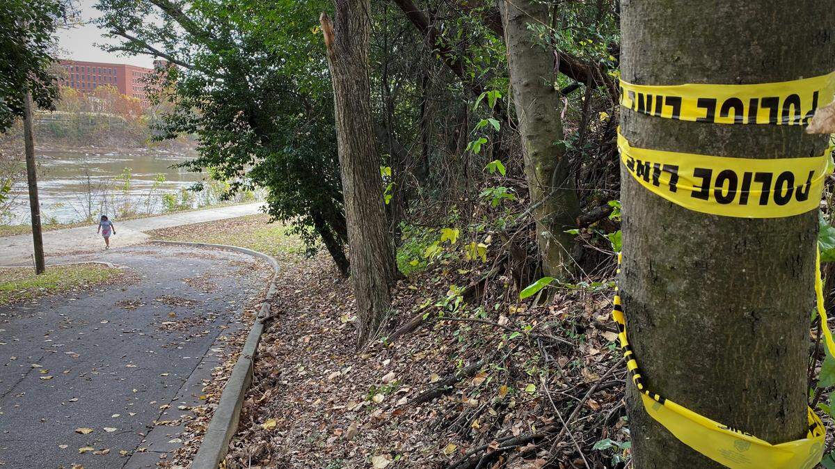 Police crime scene tape marks an entrance to the Phenix City Riverwalk, where two men fatally were shot.