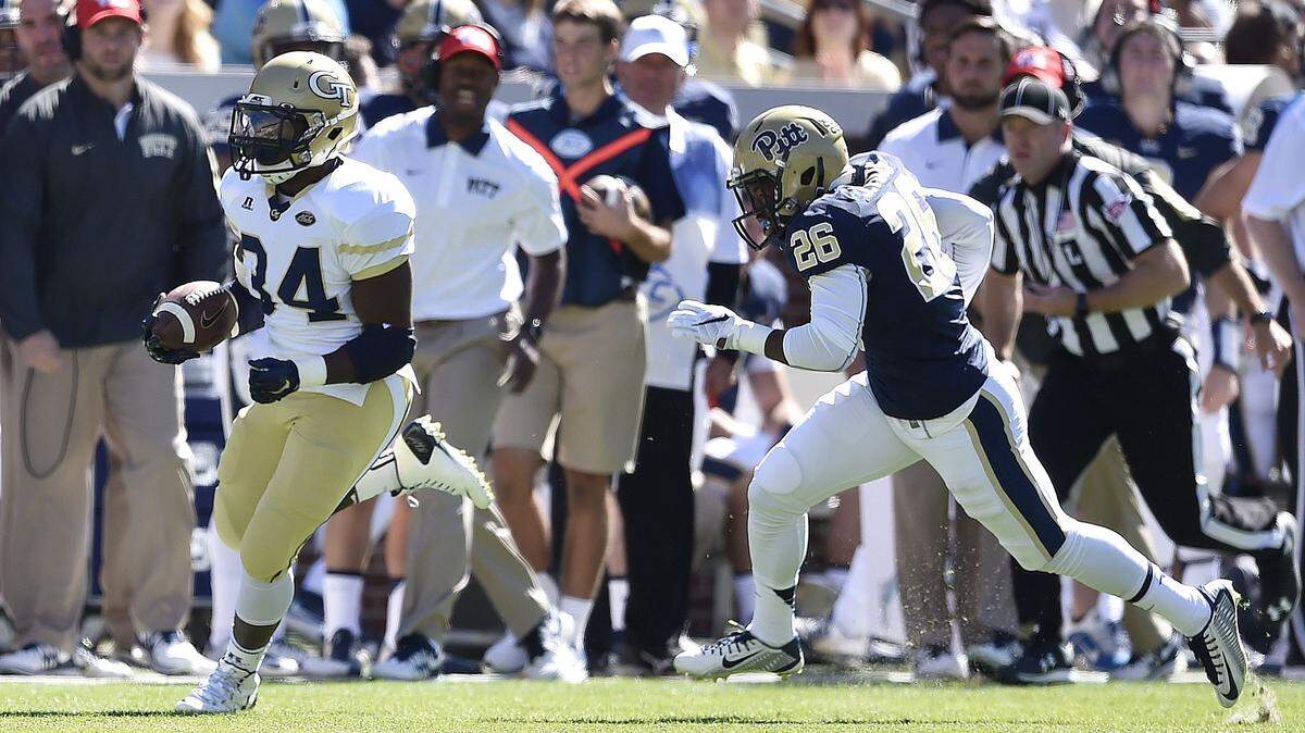 Georgia Tech running back Marcus Marshall (34) runs the ball against Pittsburgh defensive back Jevonte Pitts (26) during the first half of an NCAA college football game, Saturday, Oct. 17, 2015, in Atlanta. Marshall scored a touchdown on the play. (AP Photo/Mike Stewart)