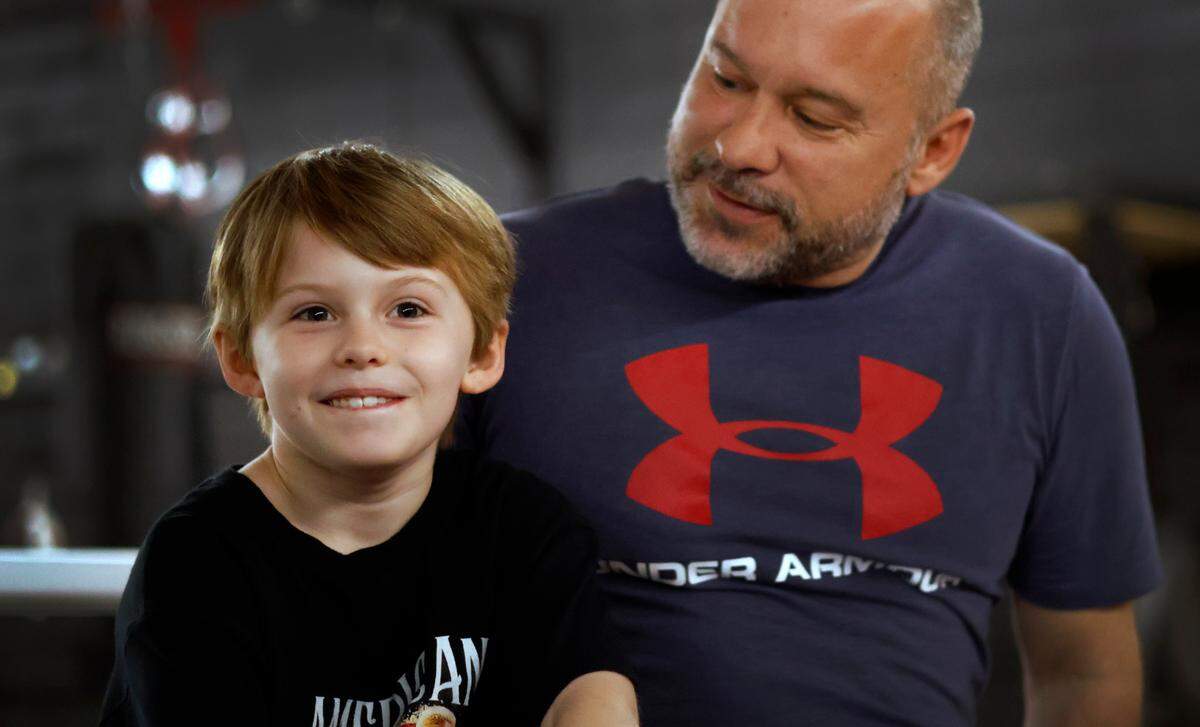 Landon Paris, left, and his father Carson Paris talk about Landon’s recently meeting WWE wrestler Cody Rhodes at WWE’s Road to Wrestle Mania in Augusta, Georgia. 03/21/2024