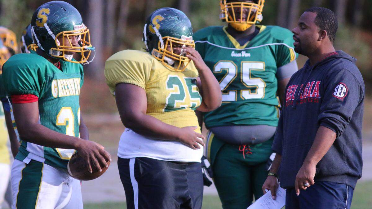 Spencer coach Pierre Coffey talks to members of the offensive line in practice Tuesday. 
 DAVID MITCHELL/dmitchell@ledger-enquirer.com