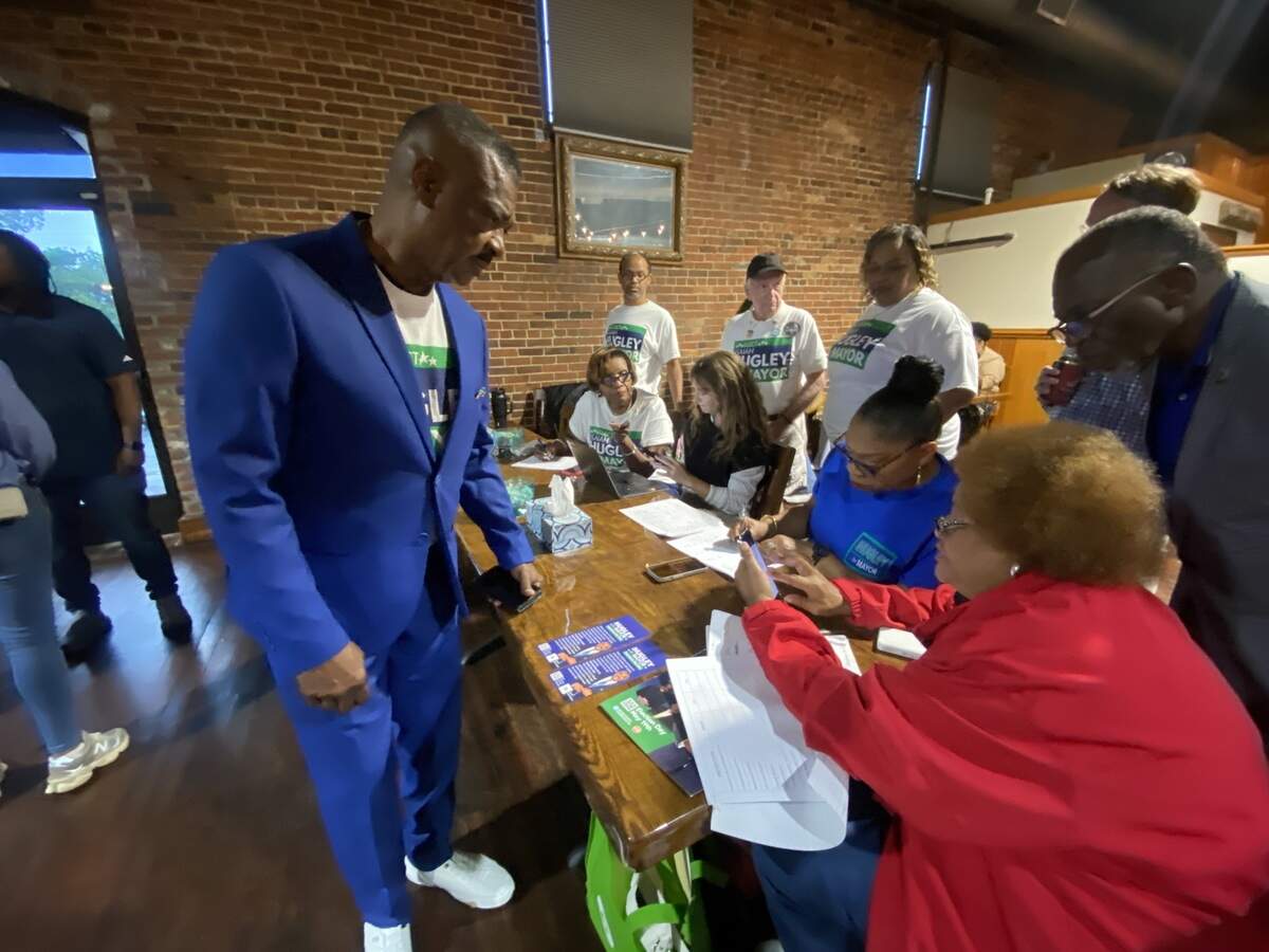 Columbus mayoral candidate Isaiah Hugley checks with his staff at his election night watch party during the June 16, 2026, runoff.