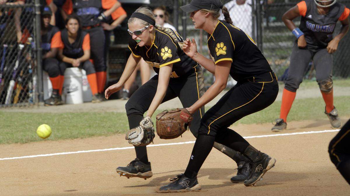 ROBIN TRIMARCHI rtrimarchi@ledger-enquirer.comHarris County infielders Lilly Hooper, left, and Morgan Charter charge a Columbus High bunt Thursday at the Lakebottom ball fields.  09.03.15