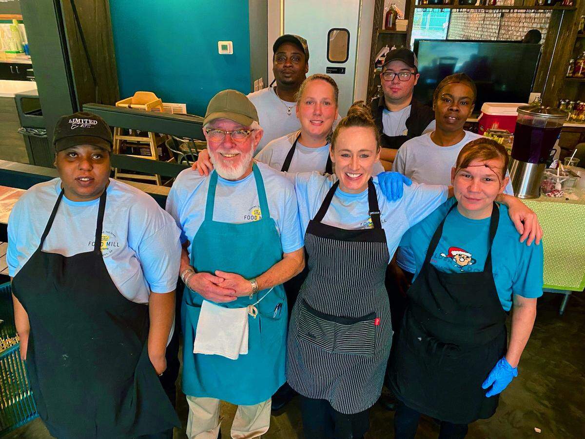 Brittney Espersen, front row and second from right, the general manager/chef at The Food Mill in Columbus, Georgia, poses for a photo in December 2023 with her kitchen team.