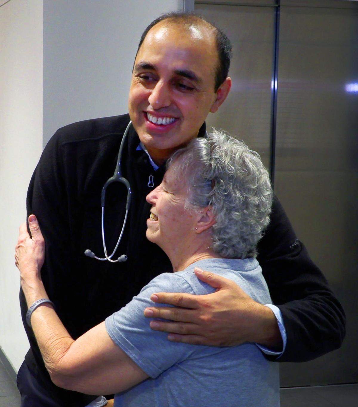 Susan Williams, a patient at the John B. Amos Cancer Center in Columbus, Georgia, hugs her physician, Dr. Mukesh Kumar, M.D. a hematologist and medical oncologist at the John B. Amos Cancer Center in Columbus, Georgia. 02/11/2025