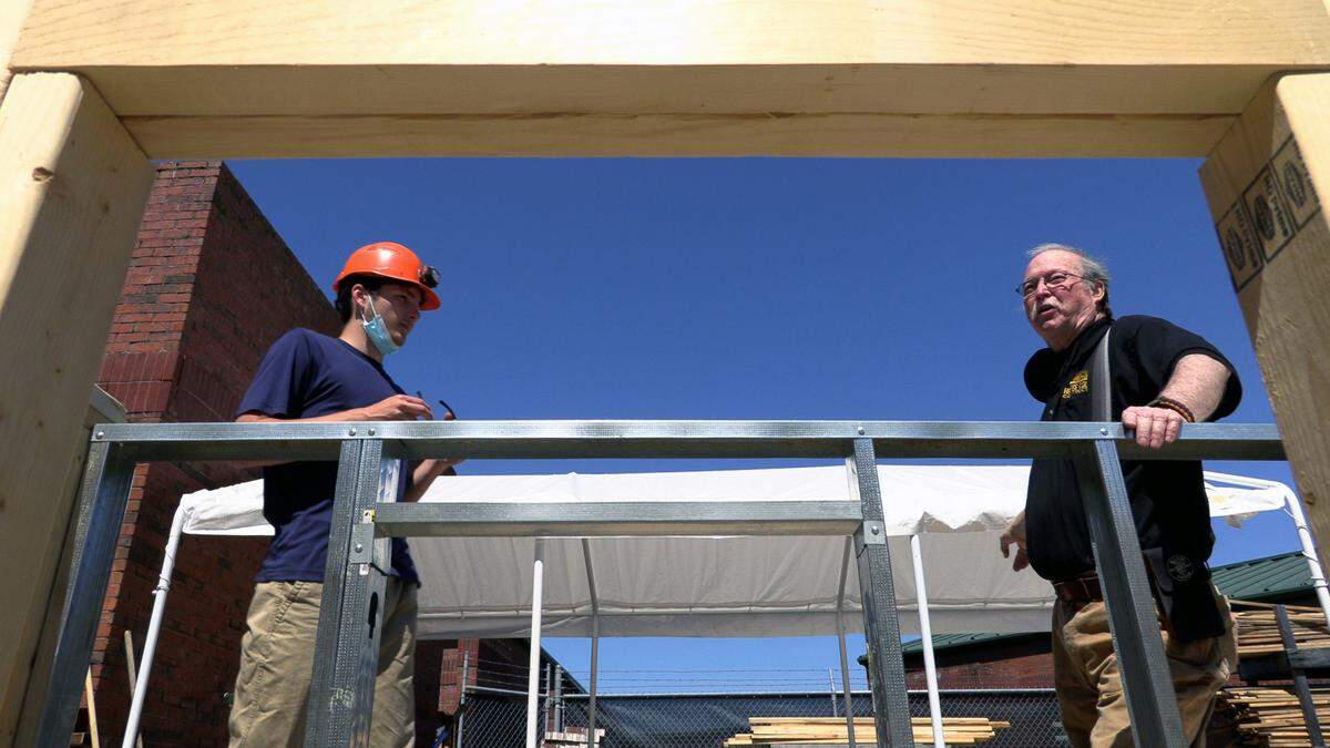 Harris County High School student Michael Watley, left, talks with Jim Steel, the school’s construction teacher.