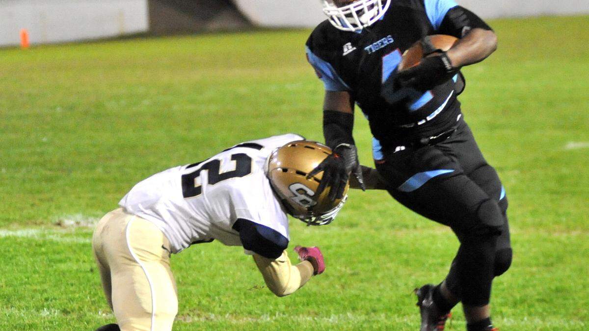 Carver's Ja`Quaze Gaines forced to the slides by Drew's Ian Leroy after a 10 yard run down to the 45 yard line in the 1st quarter of the game Friday night at Memorial Stadium