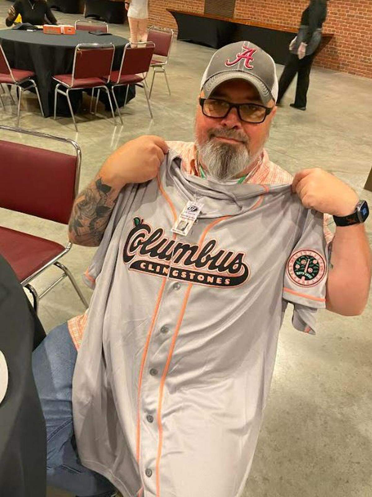 Phenix City resident George Ratley shows the Columbus Clingstones jersey he bought Sept. 6, 2024, in the Columbus Convention and Trade Center, where the Atlanta Braves Double-A minor league baseball team announced its new name during the Uptown Columbus Friday Night Concert.