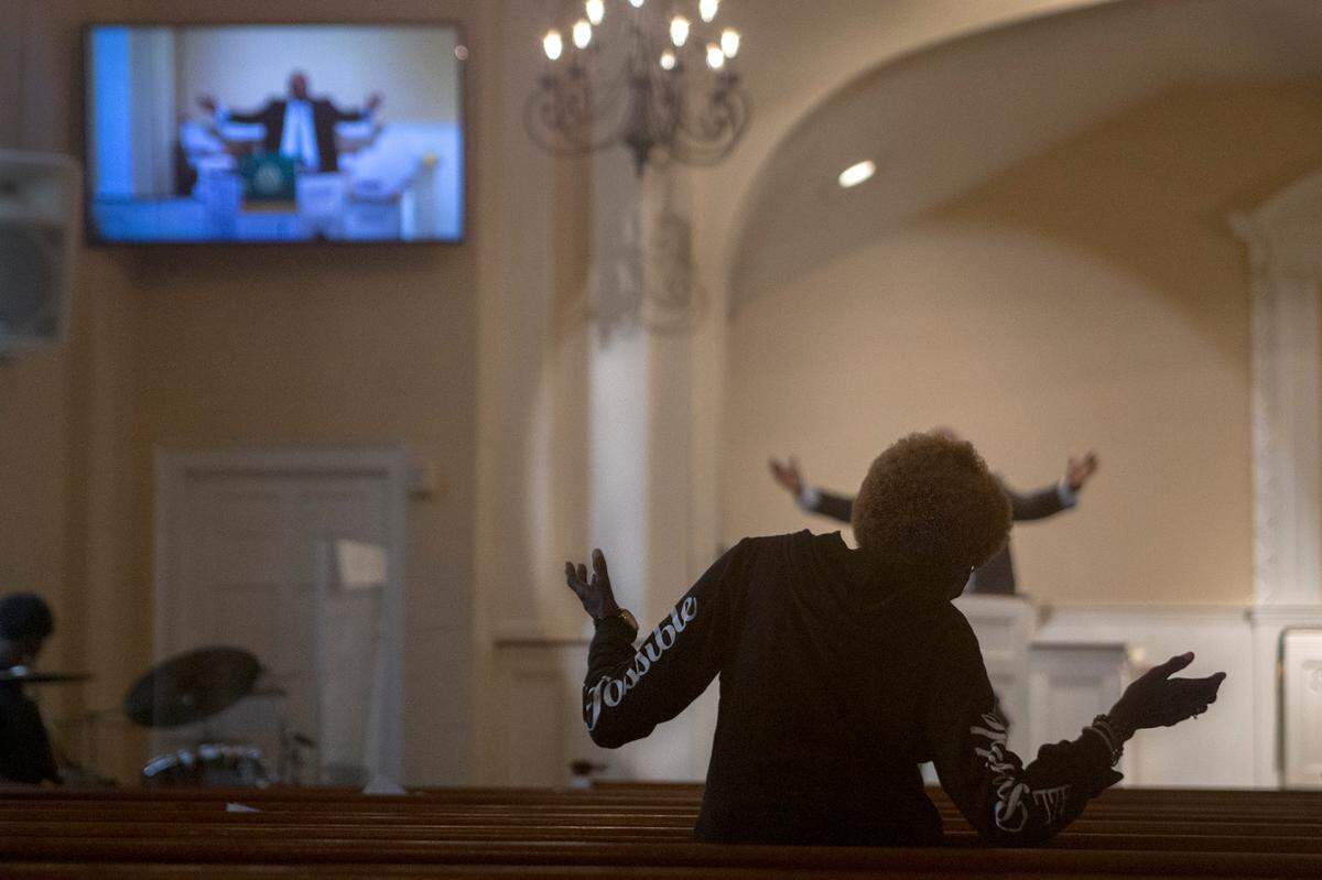 A congregant prays with Reverend Reggie Williams at South Columbus United Methodist Church on June 20, 2021. The service also was livestreamed online, one of the features implemented during the COVID-19 pandemic.