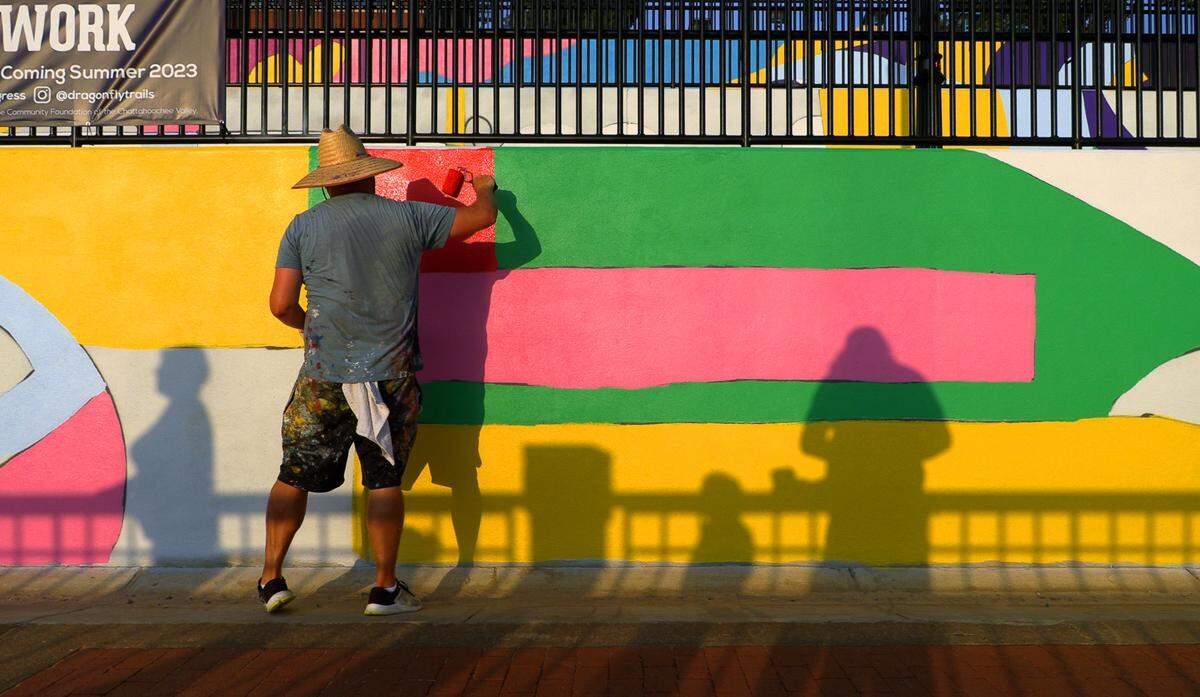 Chris Johnson, a muralist and retired Andrew College professor of art, is leading the design team in painting a mural along the Chattahoochee Riverwalk.The mural stretches along the riverbank’s three-tiered retaining wall where the Synovus Centre, 1111 Bay Ave., overlooks the Riverwalk between two of the most popular attractions on the riverfront: Waveshaper Island and Woodruff Park. 06/15/2023