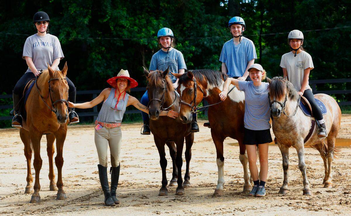 Olivia Oney, second from left, is a teacher, horse trainer, and the owner of Double O Sporthorses, in Hamilton, Georgia.