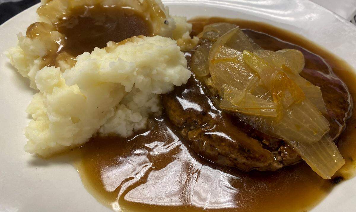 Ledger-Enquirer reporter Kelby Hutchison ordered the hamburger steak, smothered in brown gravy and sauteed onions, with a side of mashed potatoes and gravy at Cataula Creek restaurant in Harris County May 7, 2026.