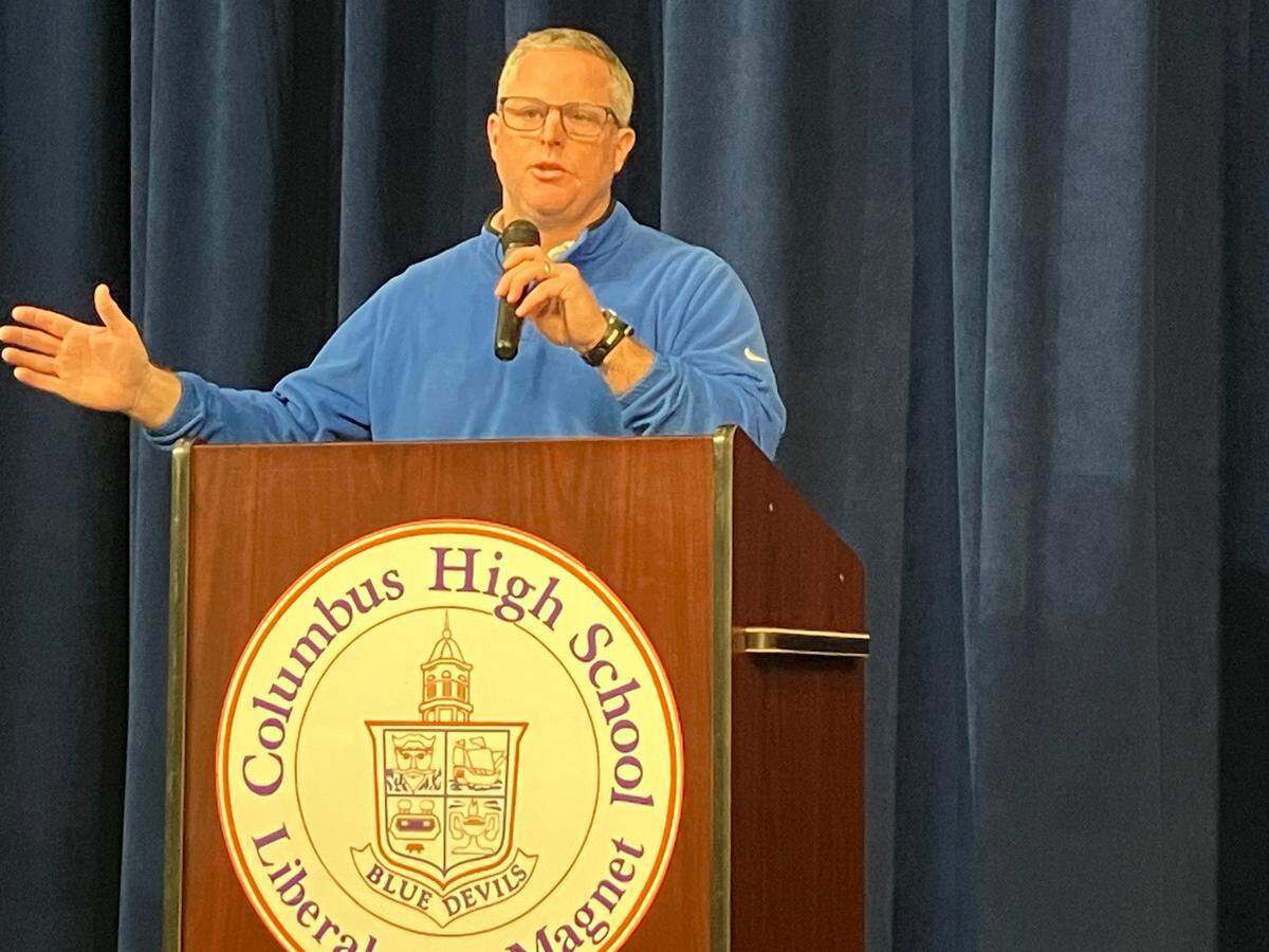 During a news conference Jan. 31, 2024, in the Columbus High School auditorium, CHS athletics director Chad Mathis announces offensive coordinator Robert “Bob” Peters has been promoted to head coach of the football team.