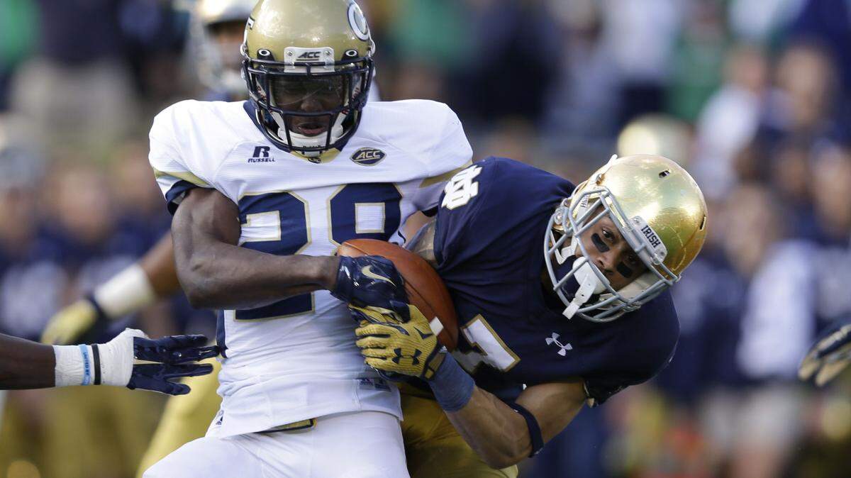 MICHAEL CONROY/Associated PressGeorgia Tech defensive back D.J. White, left, strips the ball away from Notre Dame wide receiver Will Fuller during the first half Saturday in South Bend, Ind. Notre Dame recovered the fumble.