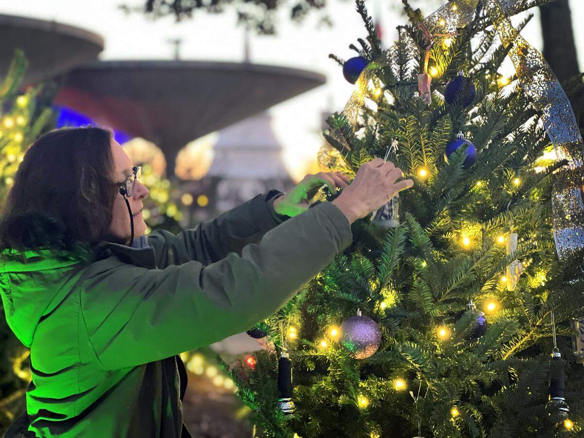 Kelly Finley hangs an ornament at Fantasy in Lights. This is the the 30th anniversary of Fantasy in Lights at Callaway Resort & Gardens. It features more than 10 million lights this year, and is Callaway Gardens’ kickoff to the holiday season, Rachael McConnell, marketing manager at Callaway Gardens. 11/18/2022