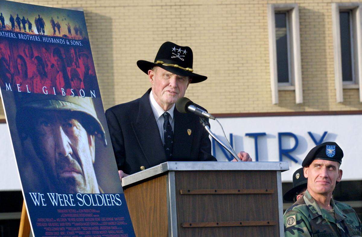 Ret. Lt. Gen. Hal Moore, co-author of the Vietnam War novel, “We Were Soldiers Once ... And Young,” shares personal stories about the battles of the Ia Drang Valley during ceremonies before the film’s premier. The gathering at Infantry Hall celebrated the Fort Benning premier showing of the film, “We Were Soldiers,” based on Moore’s novel. Col. David Rodriguez, assistant commandant of Fort Benning, is seated right.   02.13.2002