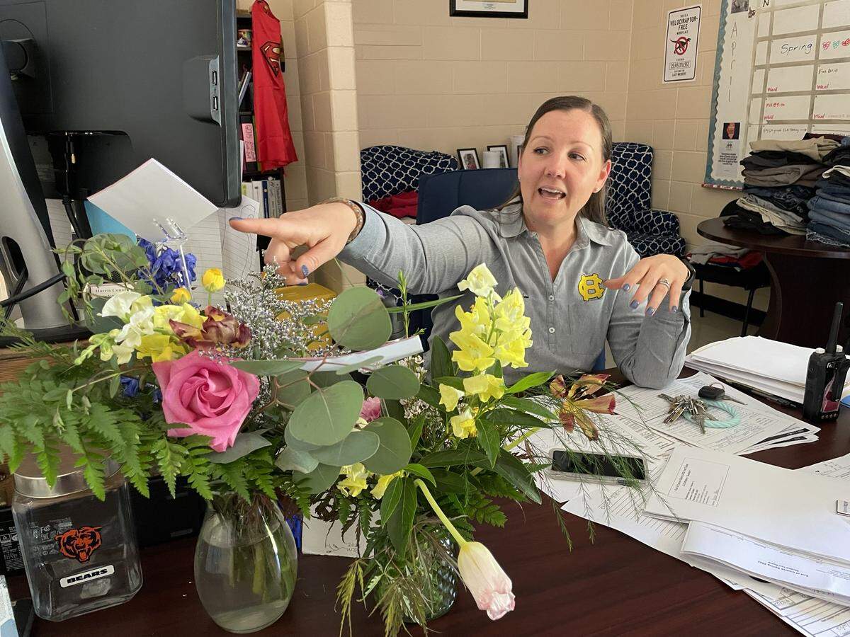 Ariane Stecher, administrator of the Educational Opportunity Center and STEPS program in the Harris County School District, points to the flowers Kellie Finnegan gave her on May 1 for Principals Day to show appreciation for her guidance.