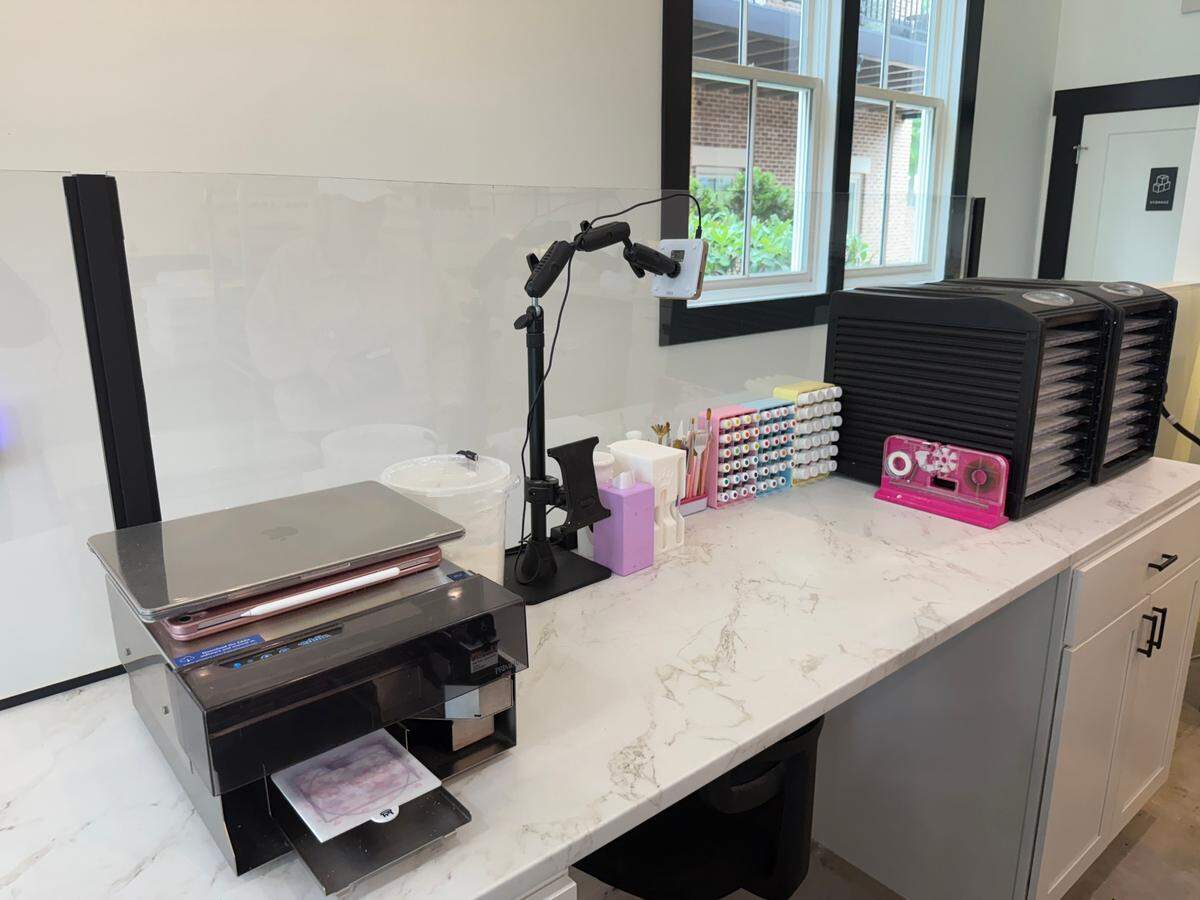 Laura Parsons, owner of The Cookie Co., 3540 Massee Lane in Columbus, bought the space with the intention of expanding her cookie decorating business. However, the gourmet cookies’ popularity has left her without time to fulfill decorating orders. Pictured is her decorating station on June 9, 2025.