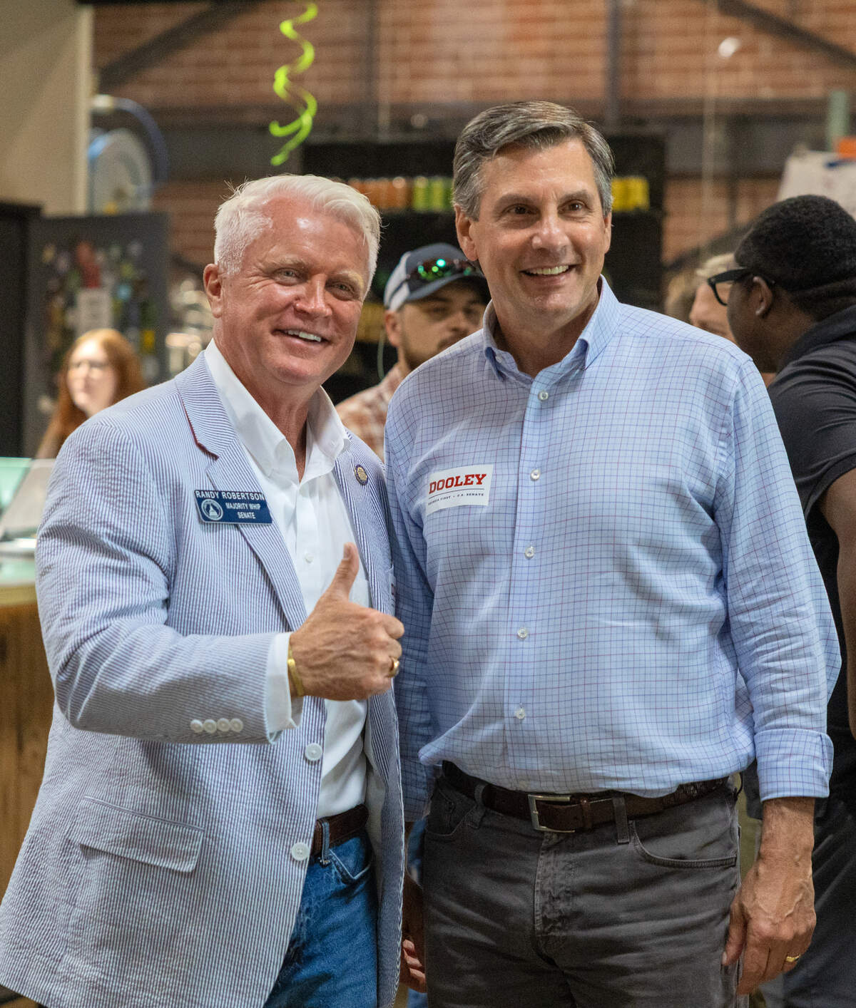 Former college football coach Derek Dooley, right, a Republican candidate for the U.S. Senate, poses for a photo with state Sen. Randy Robertson (R-Cataula) during a campaign stop June 12, 2026, in Columbus.