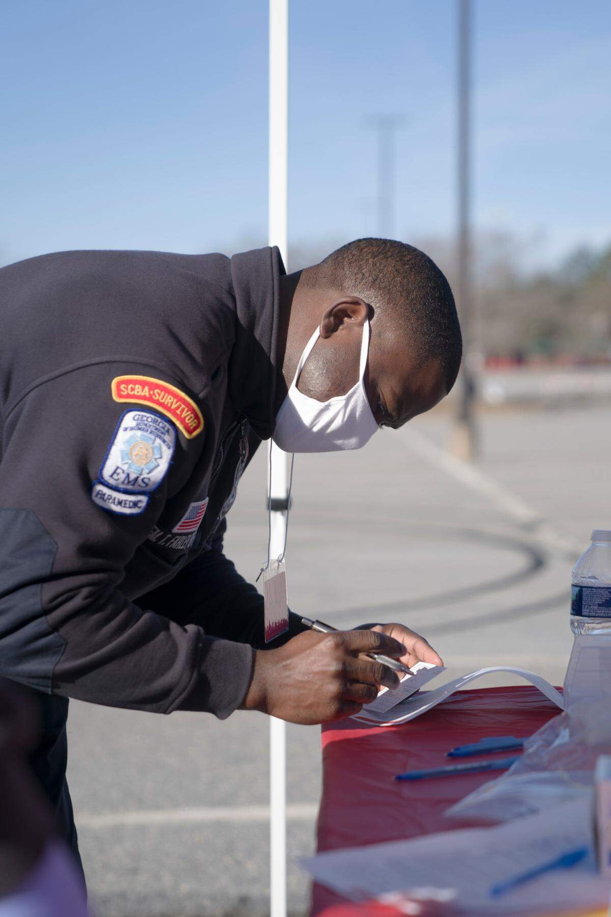 A Columbus EMT registers someone to be vaccinated at the Civic Center in Columbus, Ga., on Saturday, Jan. 23, 2021.