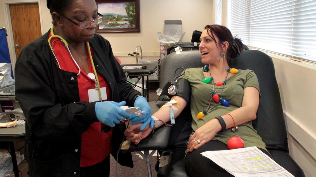 In this file photo, Lauren Tice, right, talks with other blood donors as collection specialist Michelle Boozer monitors her progress during the Gift of Life Blood Drive at the Phenix City-Russell County Public Library.
