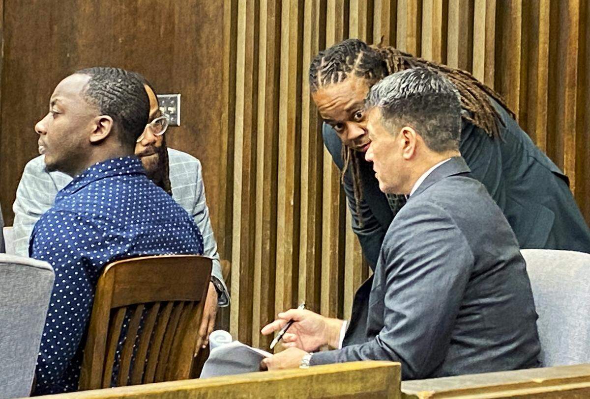 Left to right, defendant Homer Upshaw listens to testimony as attorneys William Kendrick, Shevon Thomas II and Allen Jones discuss the evidence.