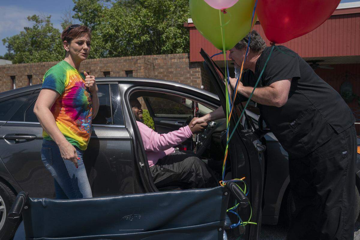 Eric Lofton says a final farewell to River Towne staff before heading home with Jenny Phillips, his girlfriend, on May 27, 2021, in Columbus, Ga. The couple are headed back to their home in Enterprise, Ala.