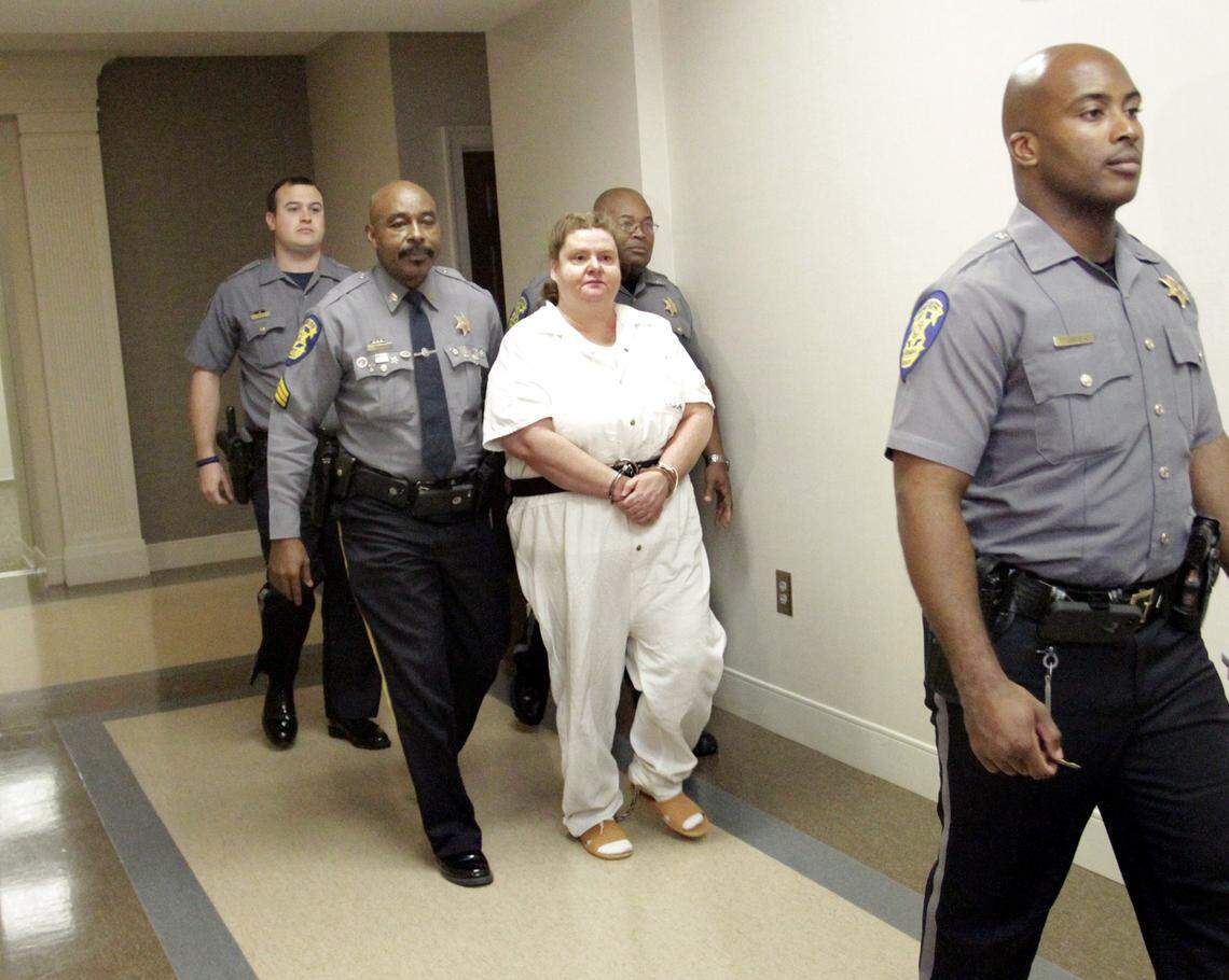 ROBIN TRIMARCHI rtrimarchi@ledger-enquirer.comRussell County Sheriffs deputies escort Lisa Graham out of court after Judge Jacob Walker III sentenced her to death for hiring gunman to kill her daughter Stephanie Shea Graham on July 5, 2007.  11.18.15