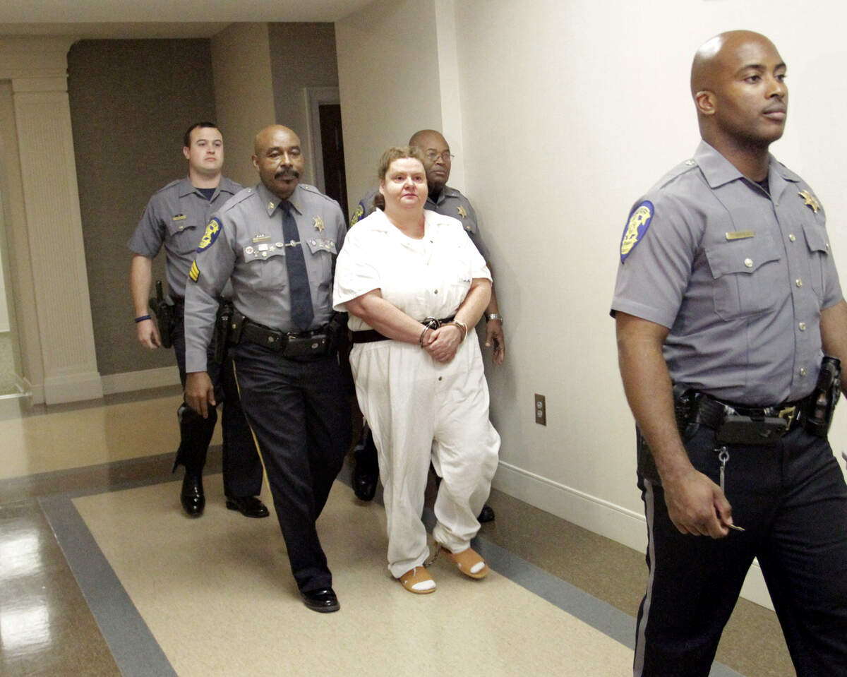 ROBIN TRIMARCHI rtrimarchi@ledger-enquirer.comRussell County Sheriffs deputies escort Lisa Graham out of court after Judge Jacob Walker III sentenced her to death for hiring gunman to kill her daughter Stephanie Shea Graham on July 5, 2007.  11.18.15