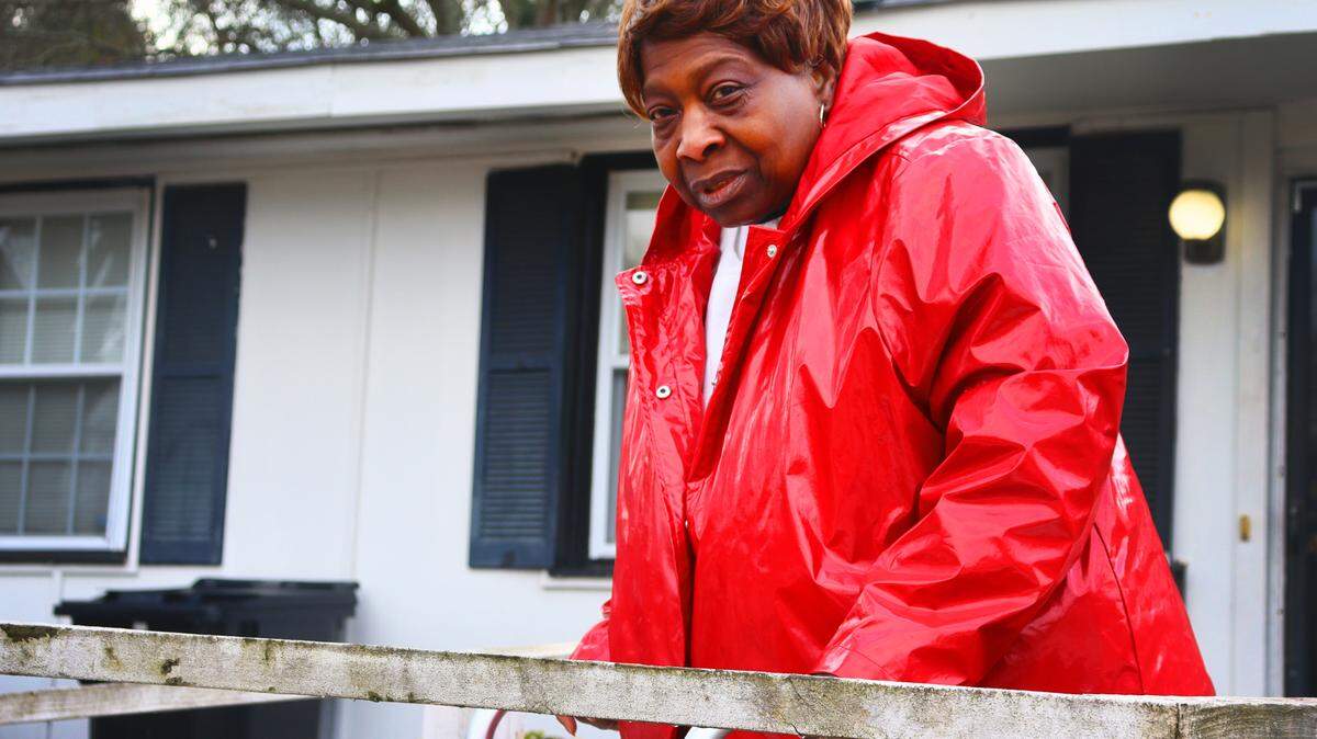 Vivian Nelson,70, stands in front of her house in Columbus, Georgia. Nelson’s broken A/C and heater were fixed for free through the weatherization program in early January. 1/16/2024.