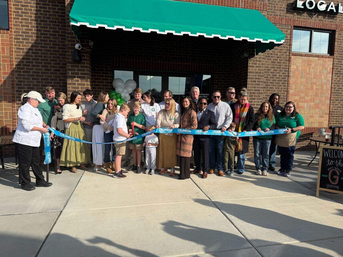 Local representatives, families and management celebrate the opening Green Island Grocery, 6801 River Road, Building J, in Columbus on Dec. 13, 2026.