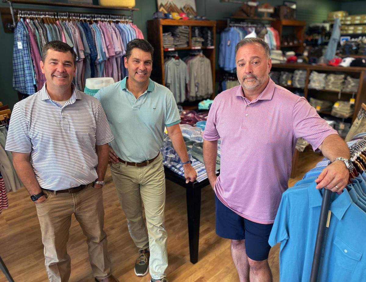 From left, Keith Paul, Greg Paul, and Scott Danford pose for a portrait inside High Pines Outfitters, a men’s clothing store they opened in October in Columbus, Georgia. They recently purchased the popular brand Southern Point Co. By acquiring Southern Point under the holding company Midland Apparel the three partners were able to bring in management and more structure to the sales team. 06/27/2023